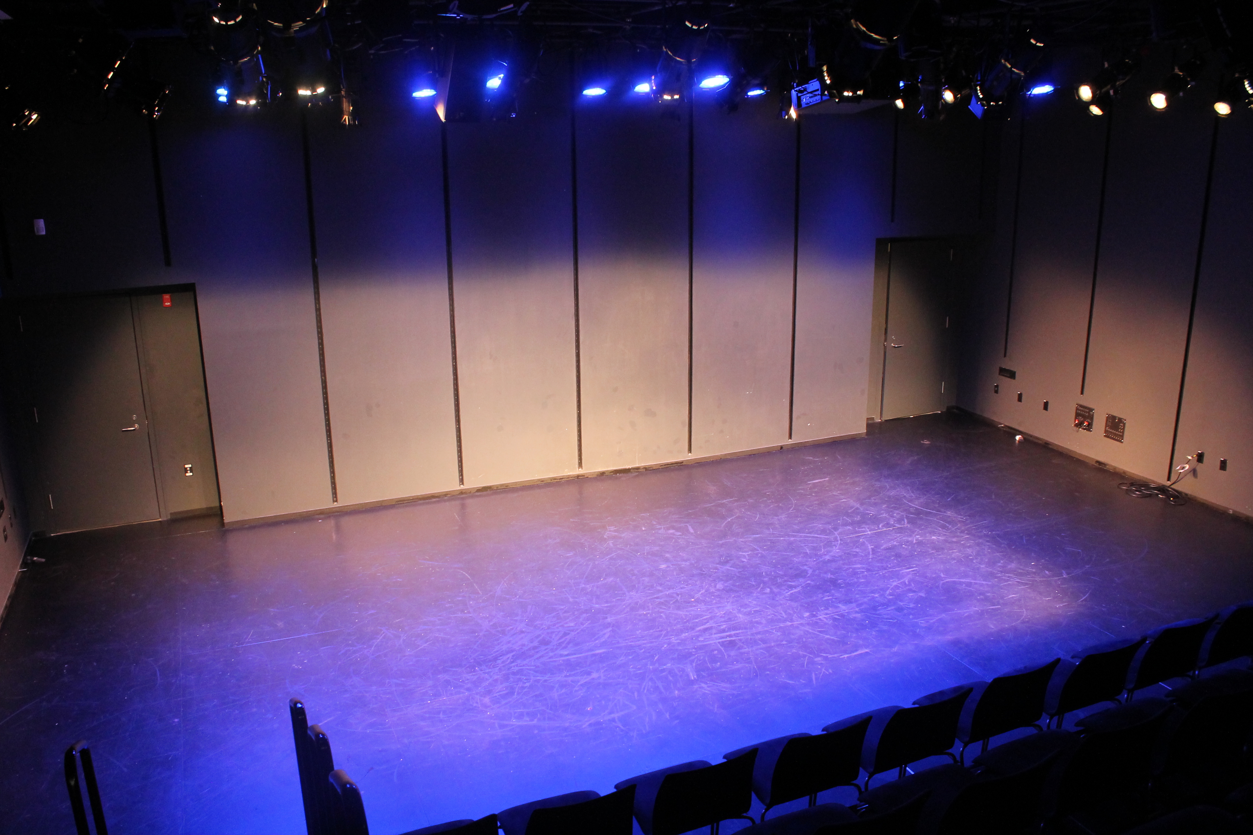 An empty theatre with a blue and purple wash.